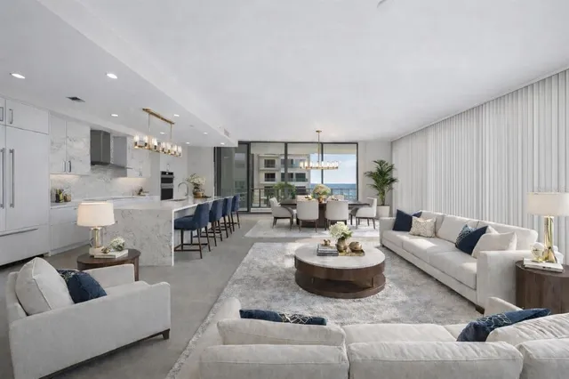 a large white kitchen with stainless steel appliances
