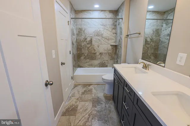a bathroom with a double vanity sink mirror and shower