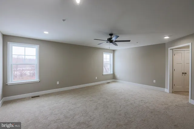 a white toilet sitting in a bathroom next to a window