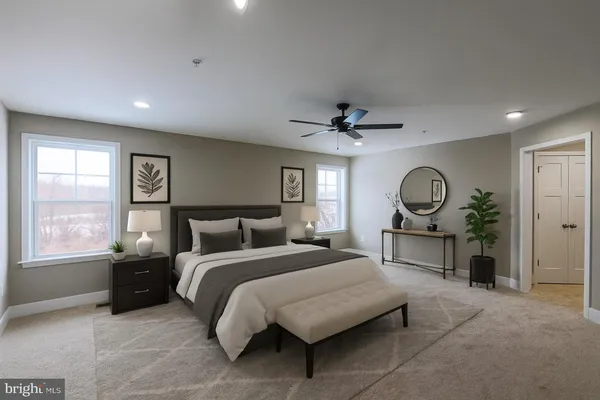 a bedroom with a bed mirror and window