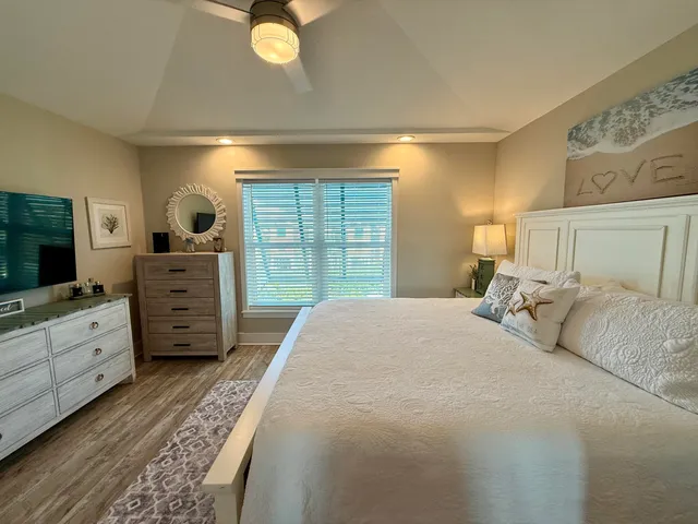 a large bed sitting in a bedroom and table
