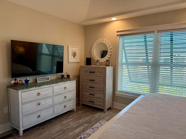 a bathroom with a granite countertop sink mirror vanity and toilet