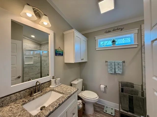 a bathroom with a shower a toilet and a sink