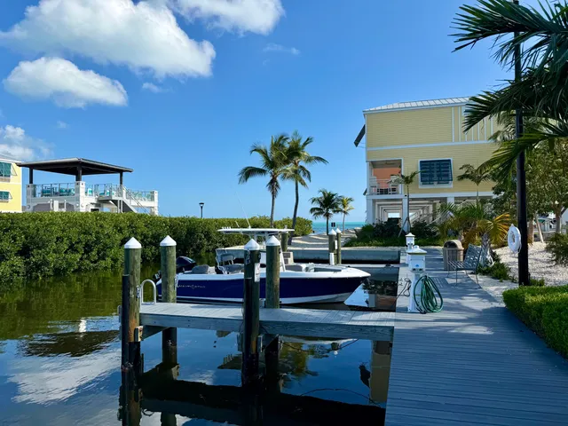 a view of a patio with table and chairs under an umbrella