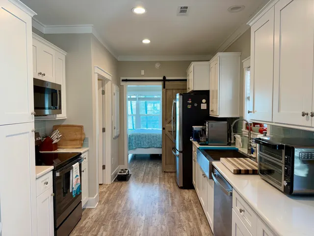 a kitchen with a refrigerator and a stove top oven