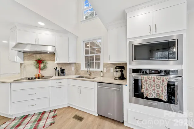 a kitchen with a sink stove and microwave