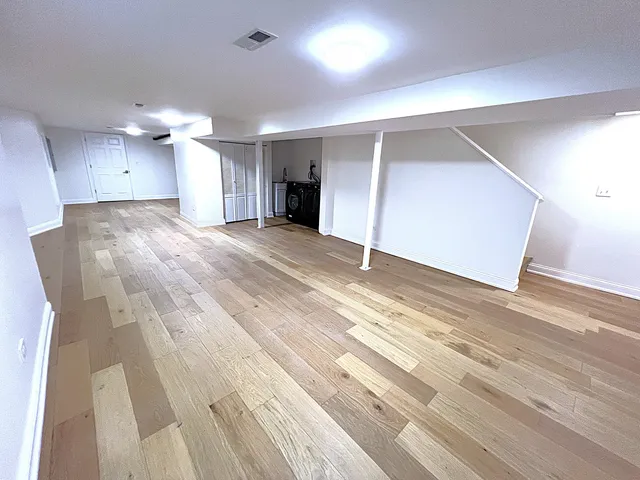 a view of a balcony with wooden floor and fence