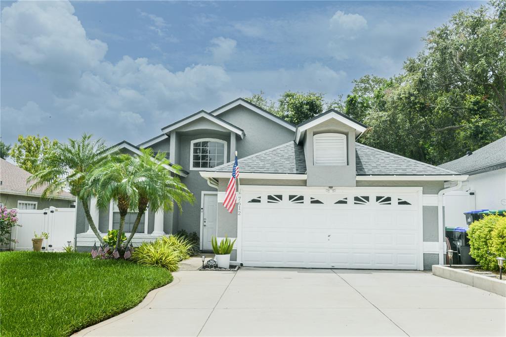 7612 Telegraph Hill Road Orlando, FL 32835 - Photo 1 of 1 a front view of a house with a garden