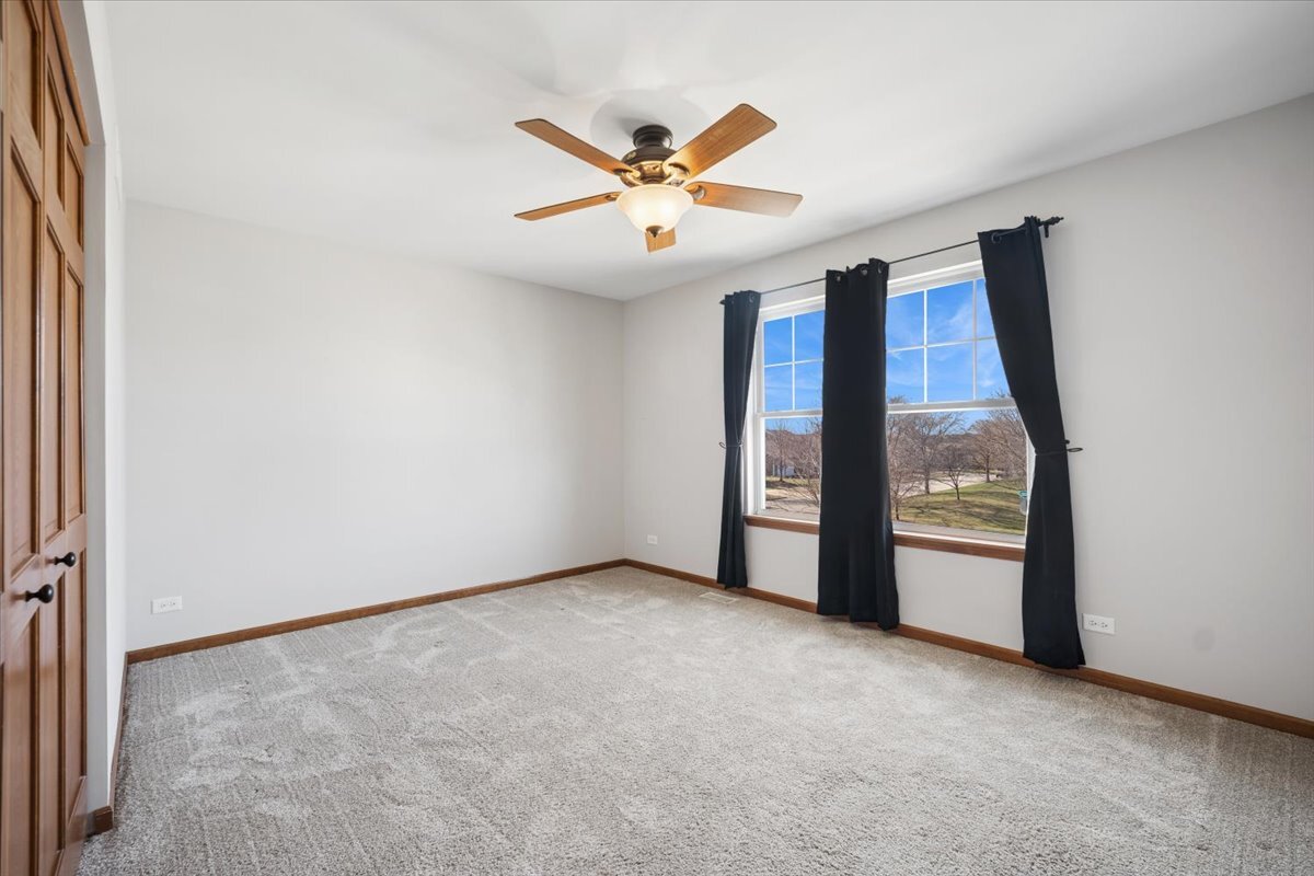 3004 Crossfire Trail Elgin, IL 60124 - Photo 13 of 25 an empty room with windows and ceiling fan