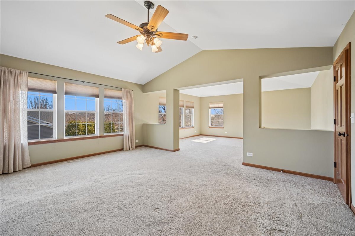 3004 Crossfire Trail Elgin, IL 60124 - Photo 16 of 25 an empty room with chandelier fan and windows