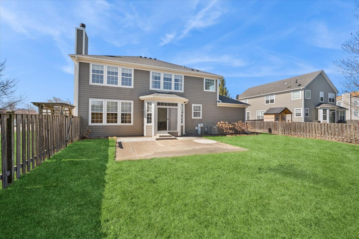 3004 Crossfire Trail Elgin, IL 60124 - Photo 20 of 25 a front view of a house with a yard table and chairs