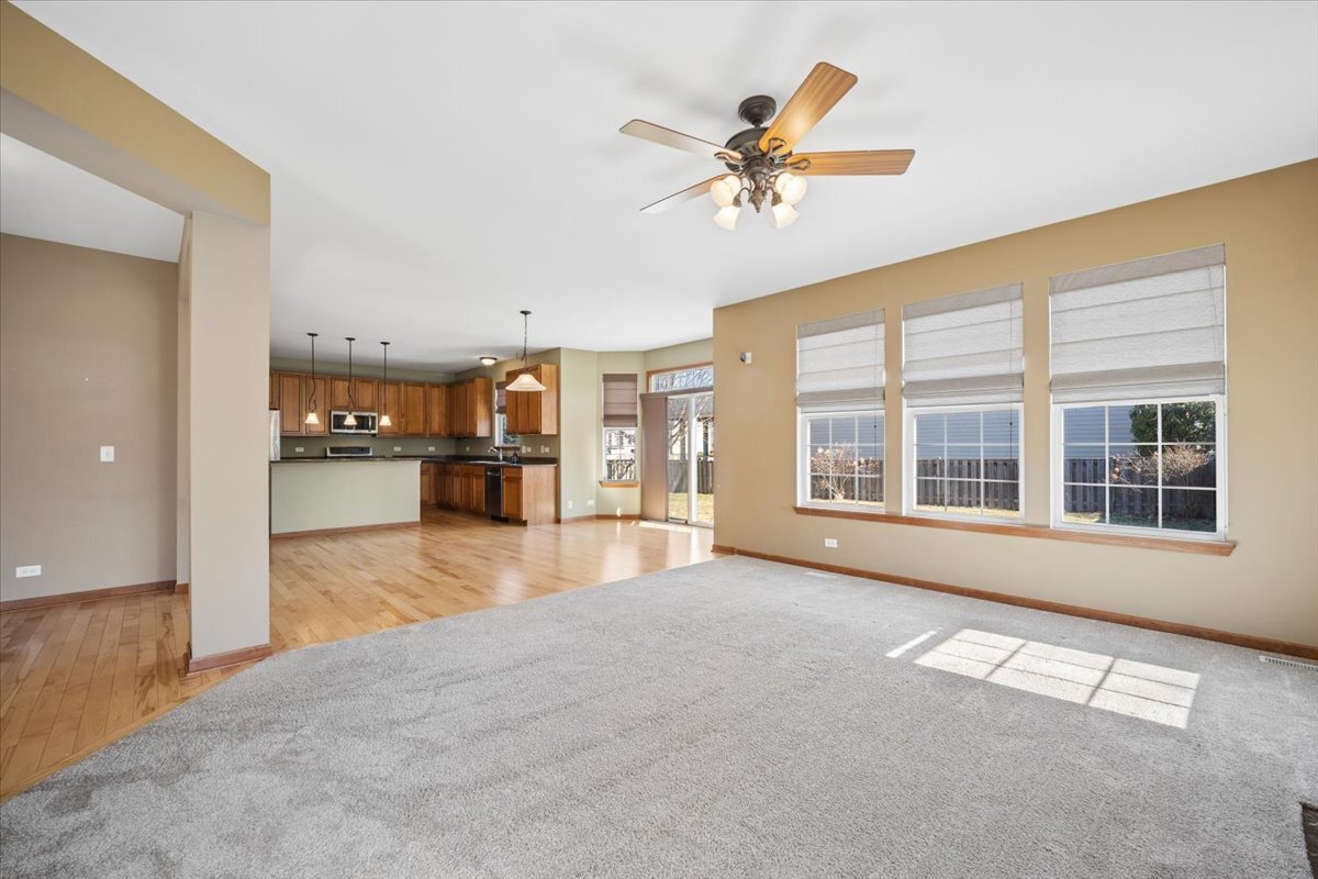 3004 Crossfire Trail Elgin, IL 60124 - Photo 7 of 25 a view of an empty room with a window and kitchen view