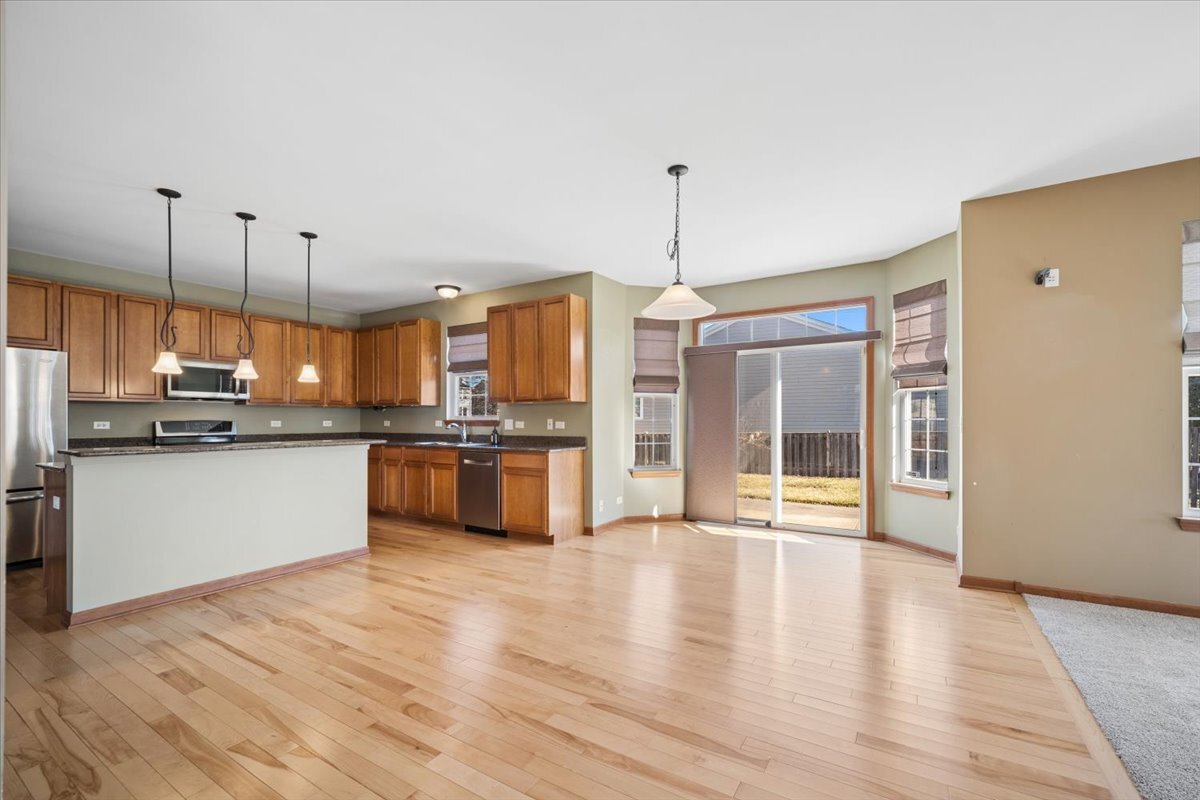 3004 Crossfire Trail Elgin, IL 60124 - Photo 8 of 25 a open kitchen with stainless steel appliances granite countertop a refrigerator a oven and a wooden floors
