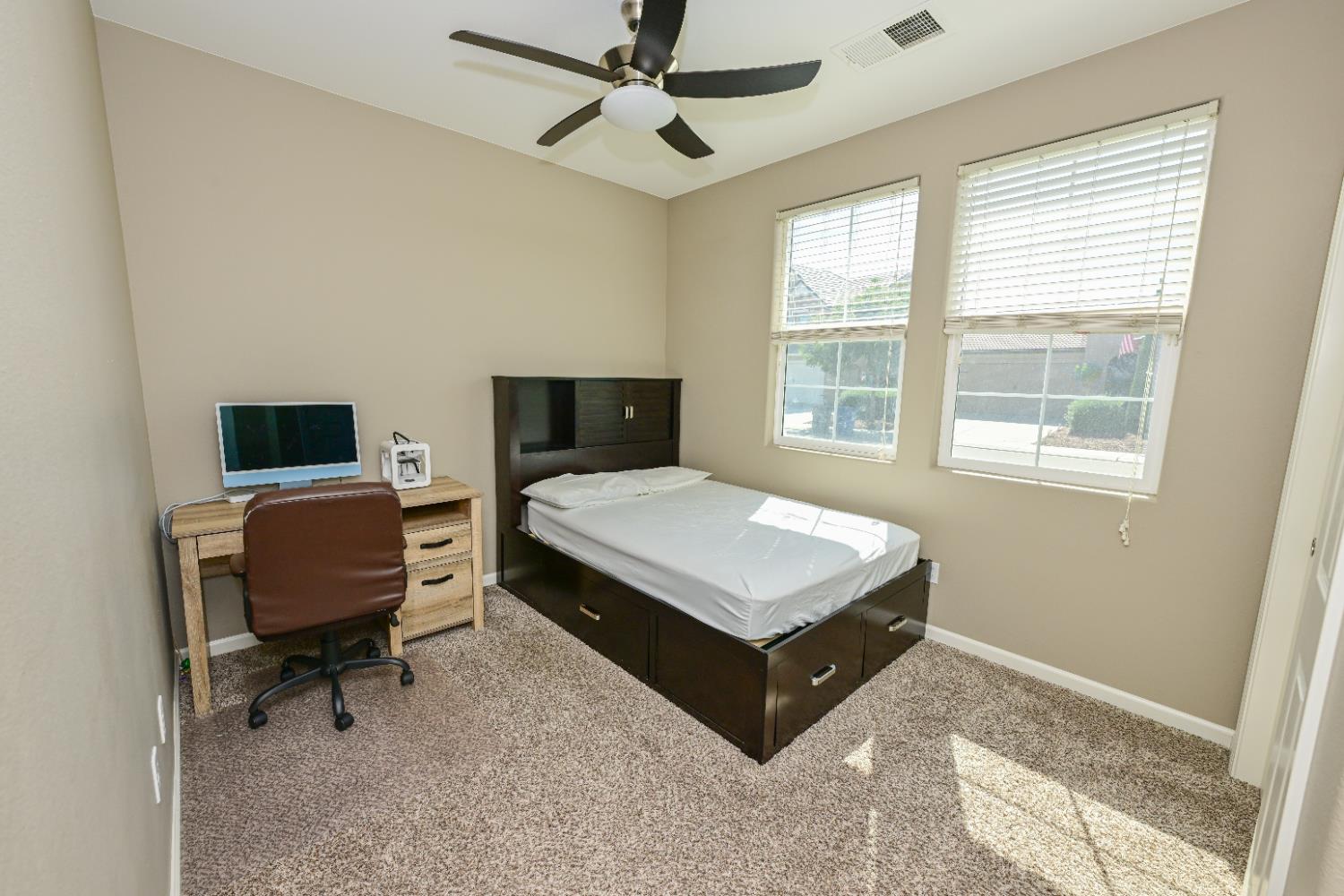 3569 Flint Avenue Clovis, CA 93619 - Photo 11 of 25 a bedroom with a bed and window