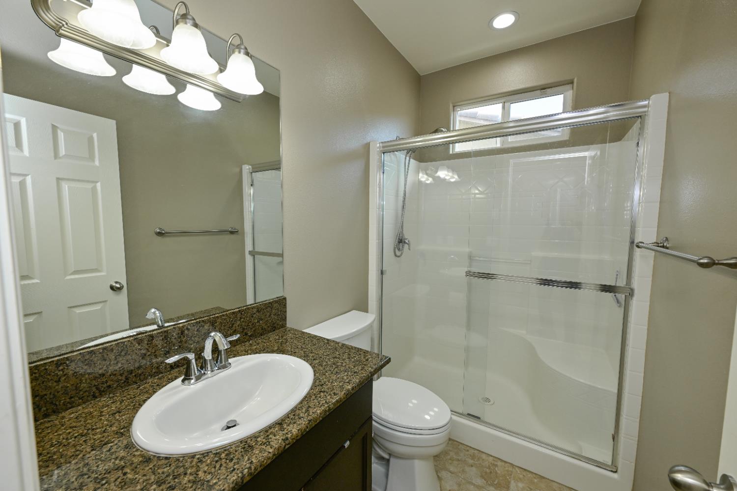 3569 Flint Avenue Clovis, CA 93619 - Photo 12 of 25 a bathroom with a sink granite counter toilet and a mirror