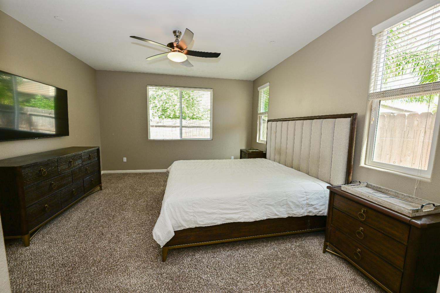 3569 Flint Avenue Clovis, CA 93619 - Photo 13 of 25 a bedroom with a bed and a flat tv screen on dresser