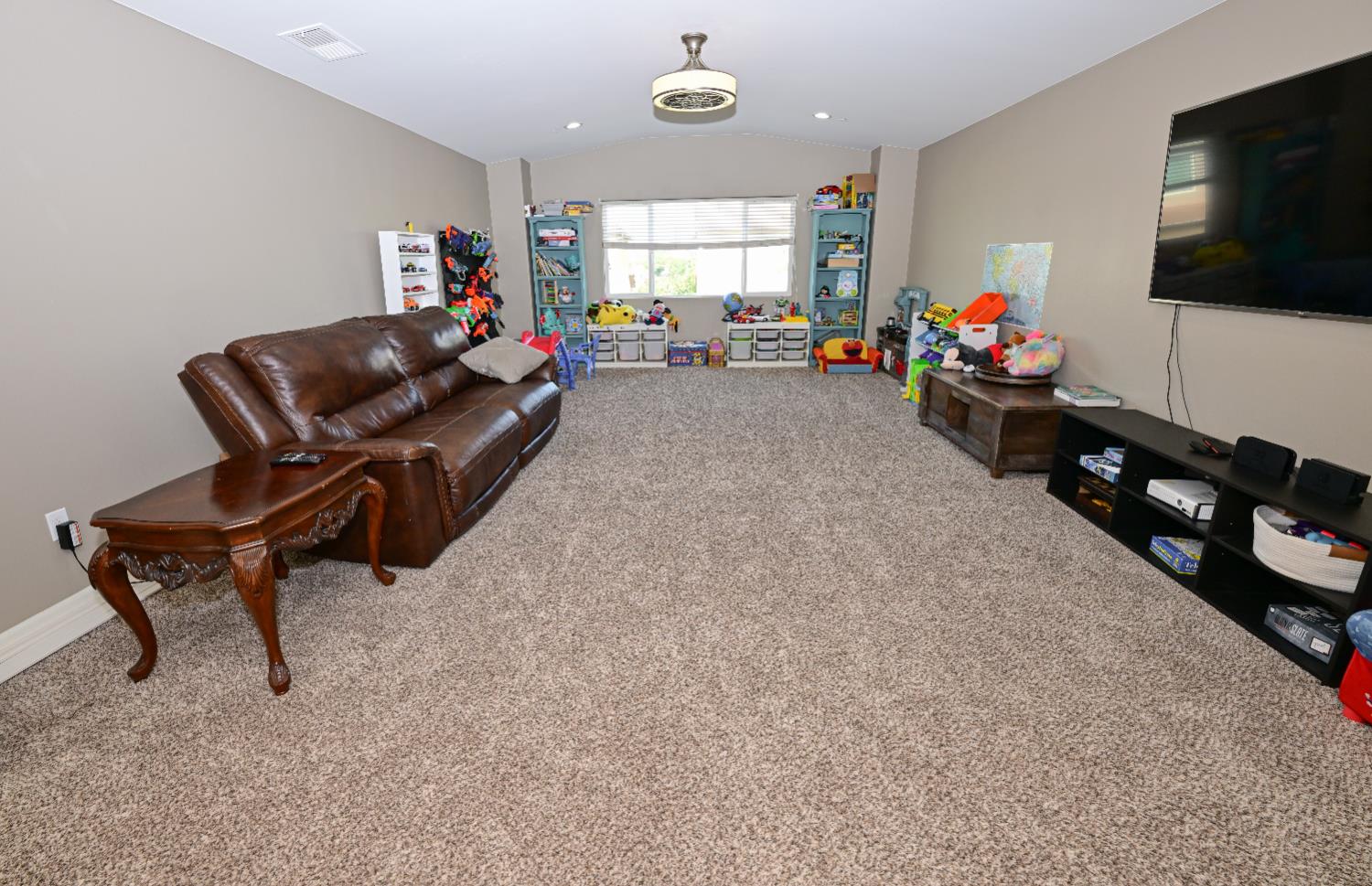 3569 Flint Avenue Clovis, CA 93619 - Photo 18 of 25 a living room with furniture and a flat screen tv