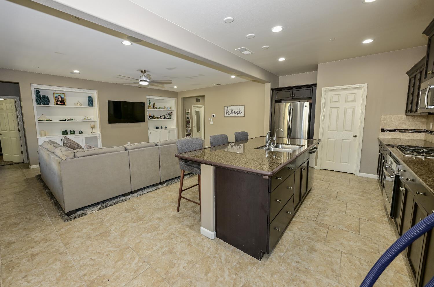 3569 Flint Avenue Clovis, CA 93619 - Photo 7 of 25 a kitchen with furniture a sink a stove and a refrigerator