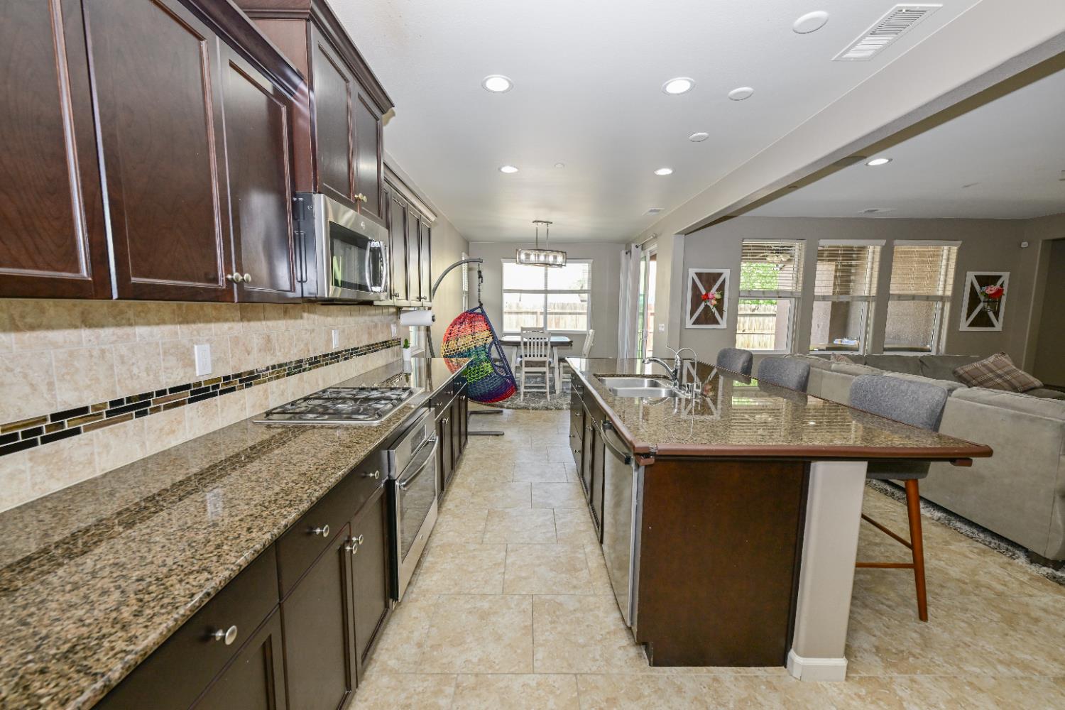 3569 Flint Avenue Clovis, CA 93619 - Photo 10 of 25 a kitchen with counter top space and stainless steel appliances