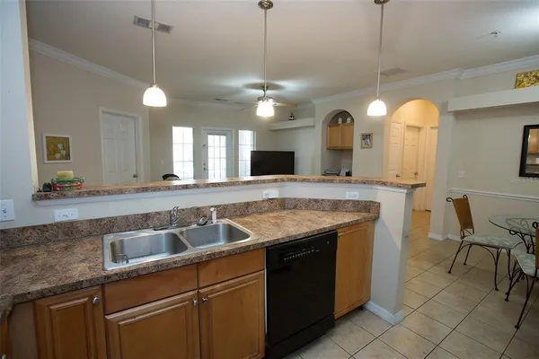 a kitchen with a sink a counter space and stainless steel appliances