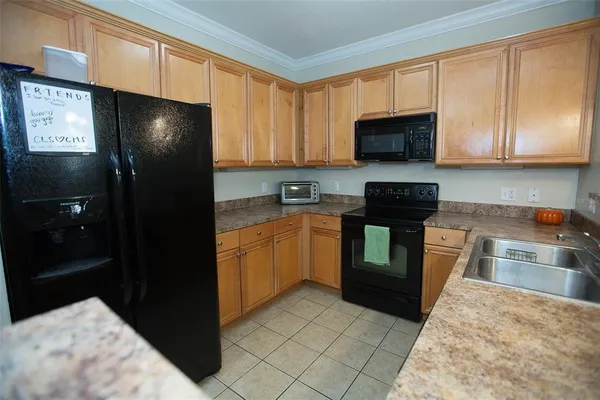 a kitchen with a refrigerator stove and sink