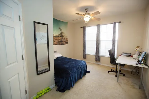 a bedroom with a workspace
