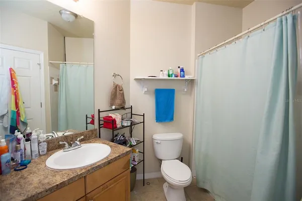 a bathroom with a sink toilet and mirror