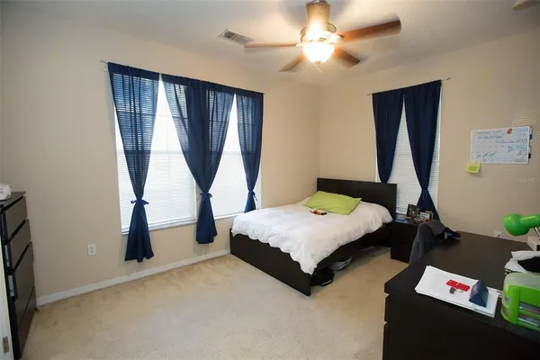 a bedroom with bed and window