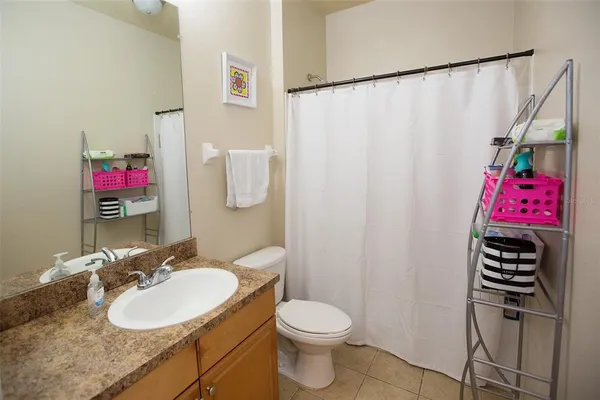a bathroom with a sink vanity mirror and toilet