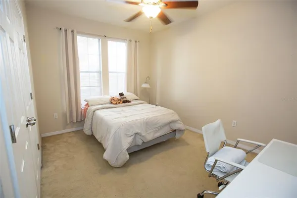 a bed sitting in a bedroom next to a window