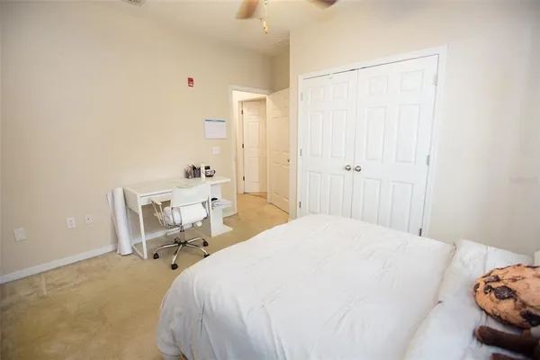 a bedroom with a bed a chair and the shower