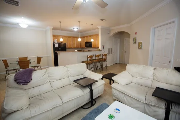 a living room with furniture and a chandelier