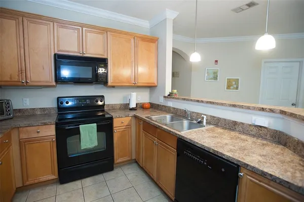 a kitchen with a sink stove and microwave