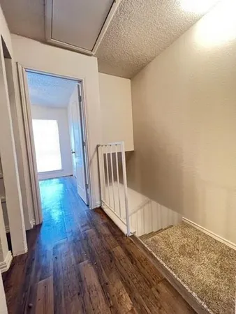 a view of hallway with wooden floor