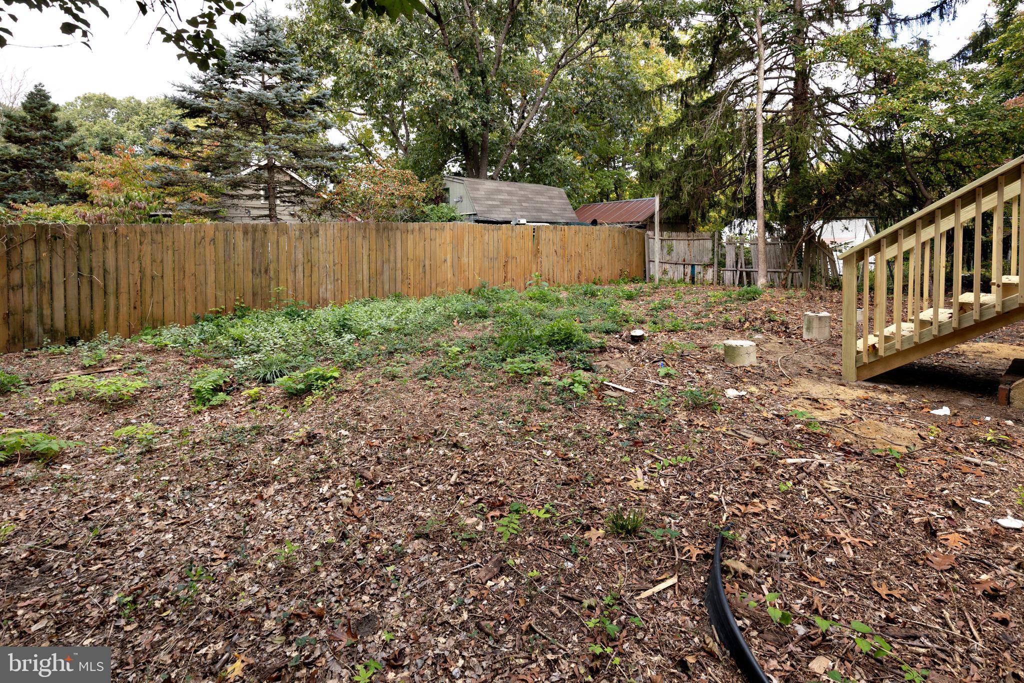 15 Jerome Terrace Clementon, NJ 08021 - Photo 32 of 33 a view of a backyard with large trees and wooden fence