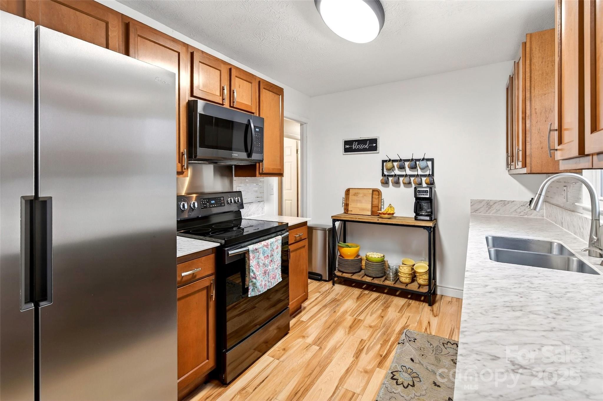 45 Due West Road Hendersonville, NC 28792 - Photo 14 of 45 a kitchen with granite countertop a refrigerator stove and sink