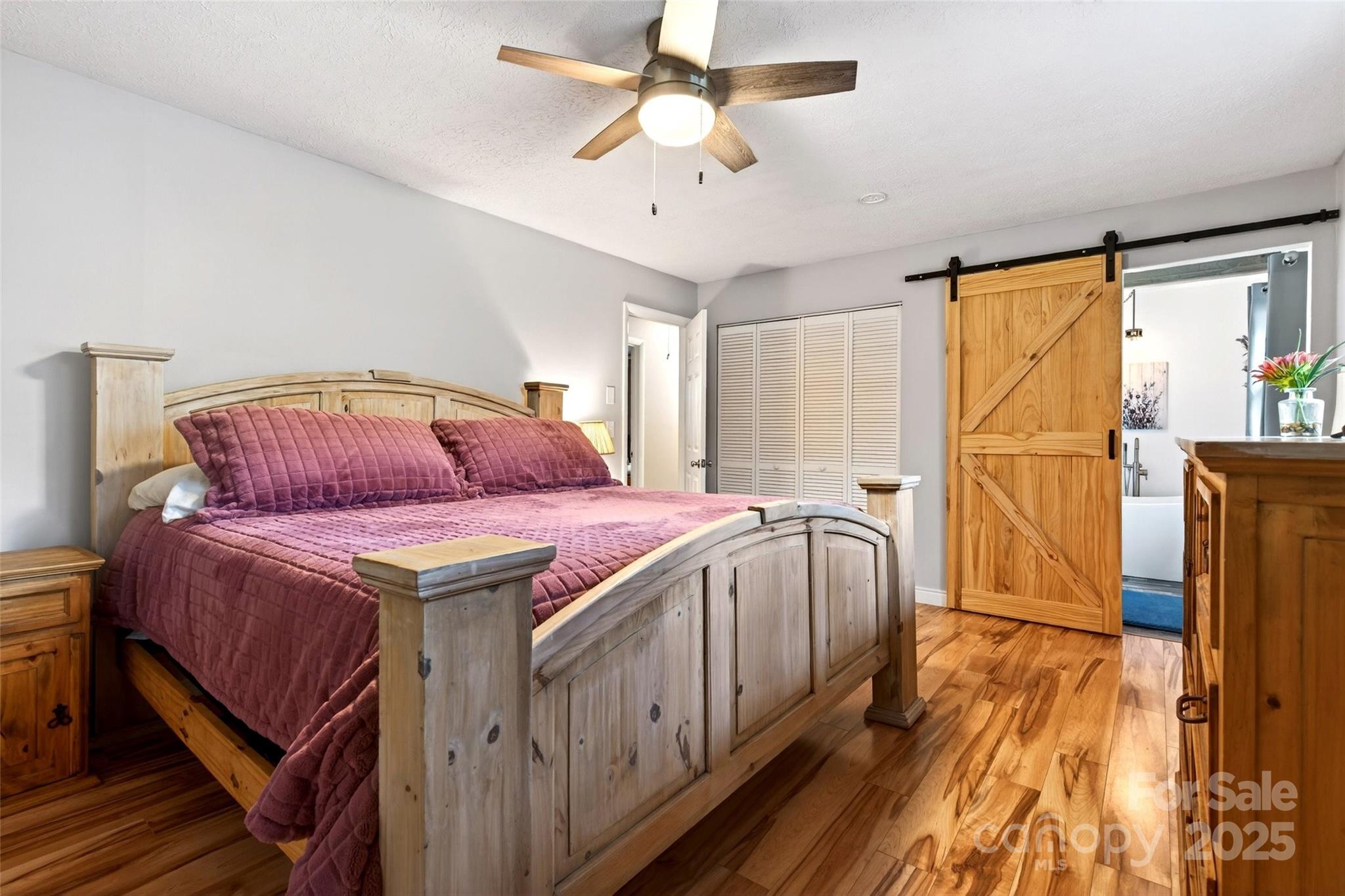 45 Due West Road Hendersonville, NC 28792 - Photo 15 of 45 a bedroom with a bed and a chandelier