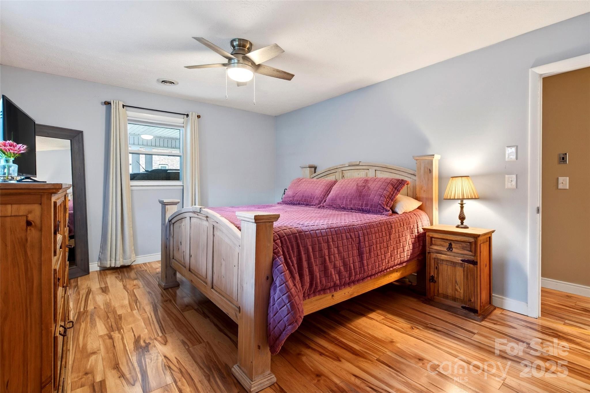 45 Due West Road Hendersonville, NC 28792 - Photo 16 of 45 a bedroom with a bed and a chandelier