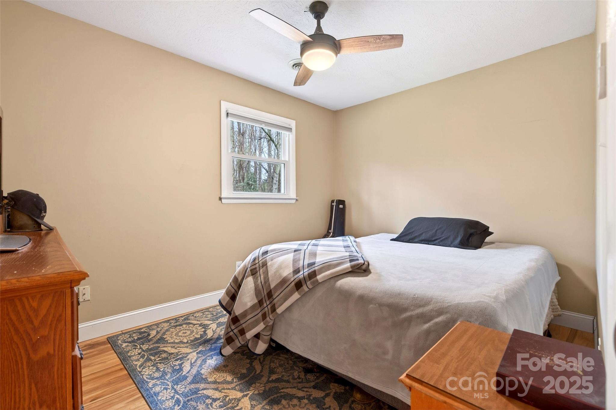 45 Due West Road Hendersonville, NC 28792 - Photo 23 of 45 a bedroom with a bed and a chandelier