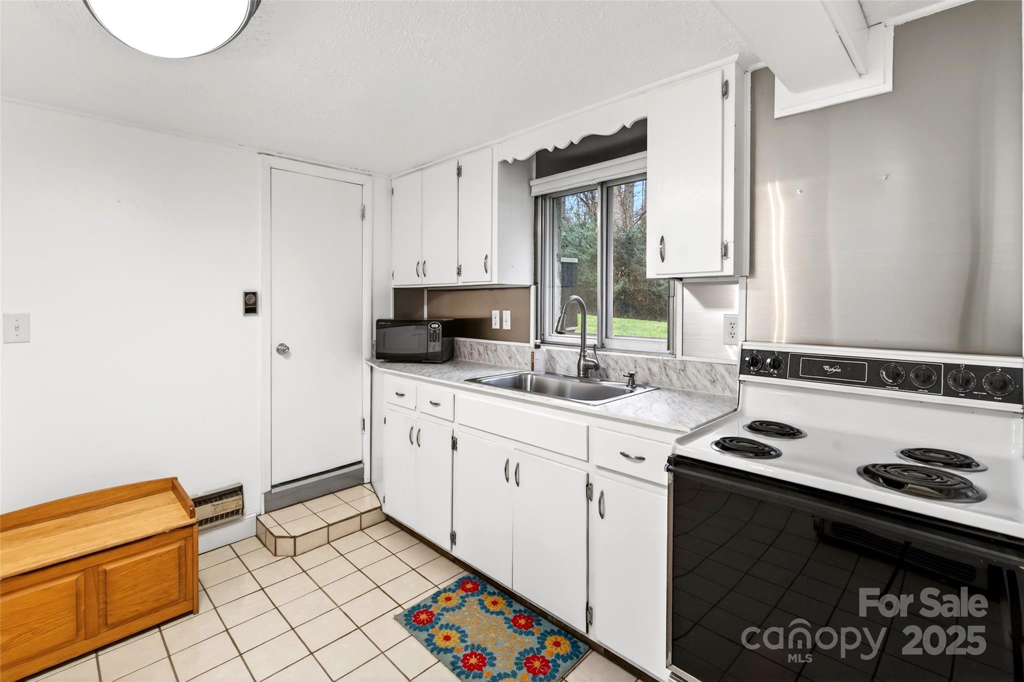 45 Due West Road Hendersonville, NC 28792 - Photo 28 of 45 a kitchen with a sink stove and cabinets