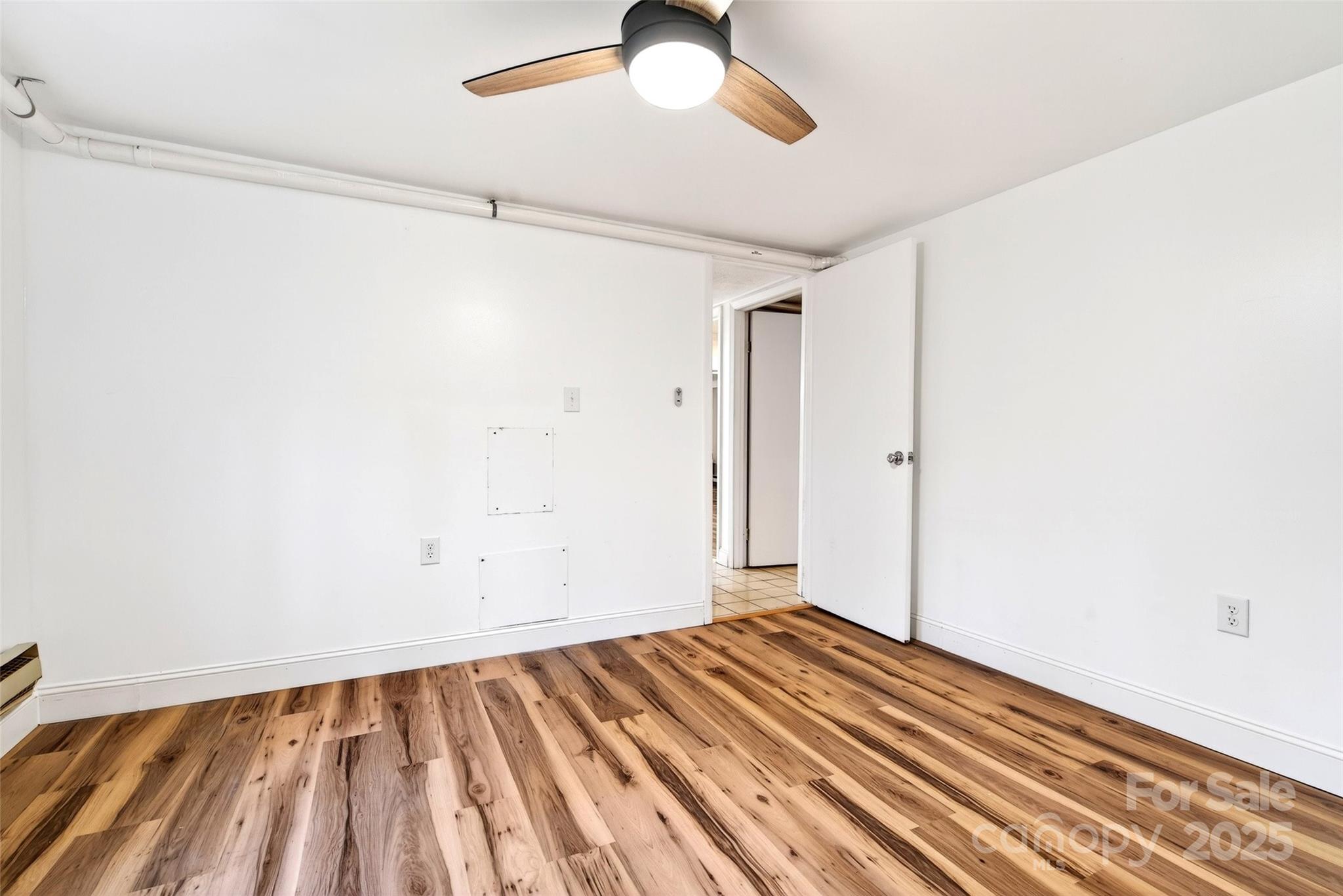 45 Due West Road Hendersonville, NC 28792 - Photo 35 of 45 a view of a room with wooden floor a ceiling fan and closet