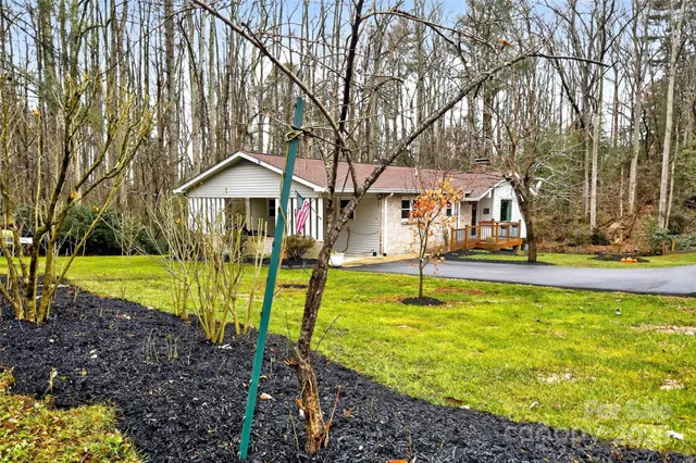 a view of a house with swimming pool and a yard