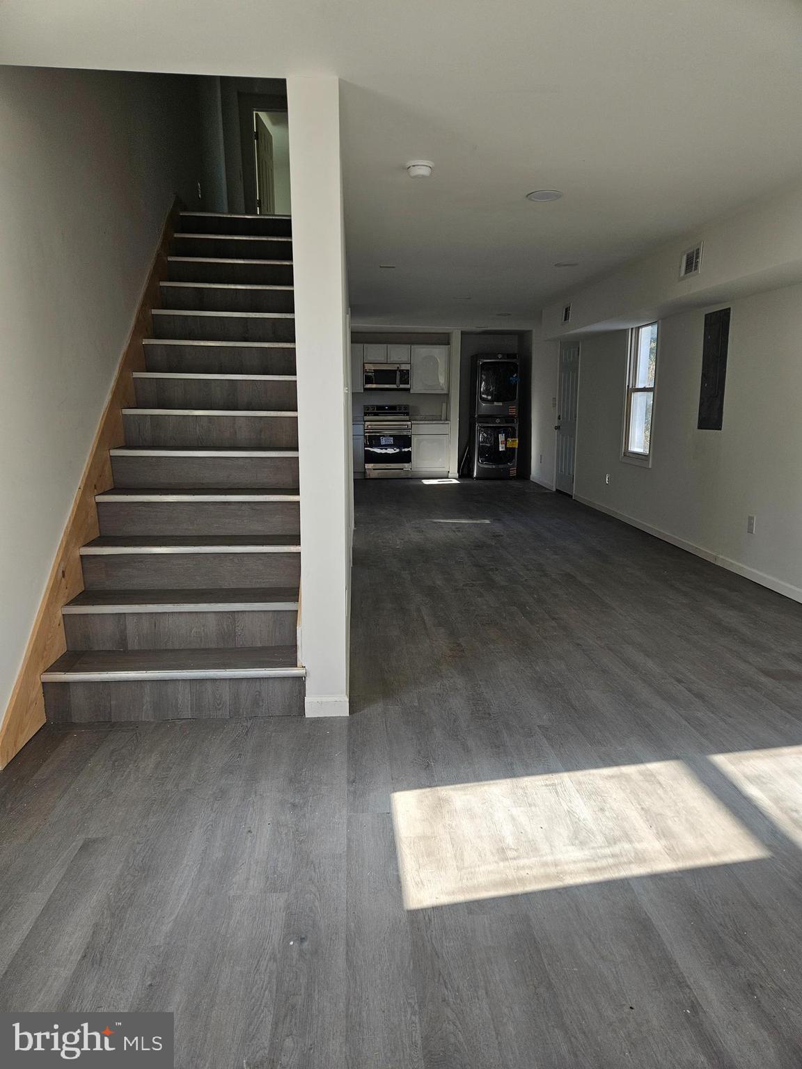 a view of entryway and hall with wooden floor