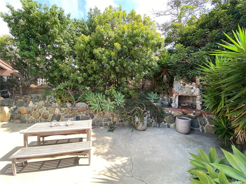 30772 Marilyn Drive Laguna Beach, CA 92651 - Photo 14 of 26 a view of a patio with table and chairs potted plants and large tree