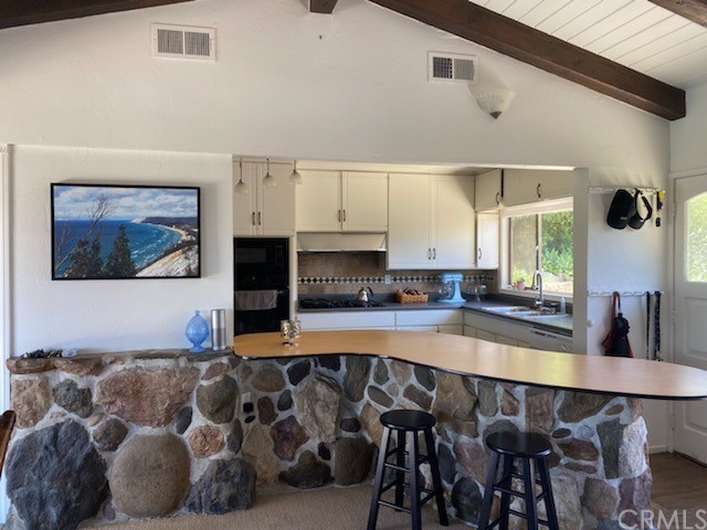 30772 Marilyn Drive Laguna Beach, CA 92651 - Photo 8 of 26 a living room with stainless steel appliances kitchen island granite countertop furniture and a fireplace
