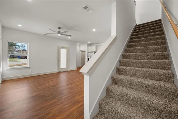 a view of entryway and hall with wooden floor