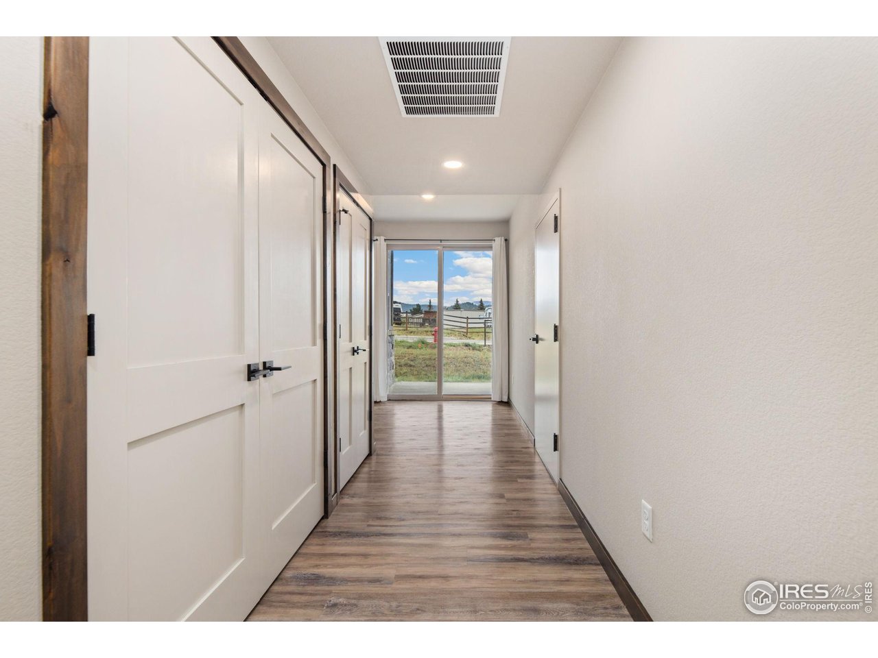 1734 Wildfire Road, Unit 102 Estes Park, CO 80517 - Photo 16 of 33 Doors on the left include the mechanical closet, washer/dryer, and coat closet. Door on the right is your heated garage.
