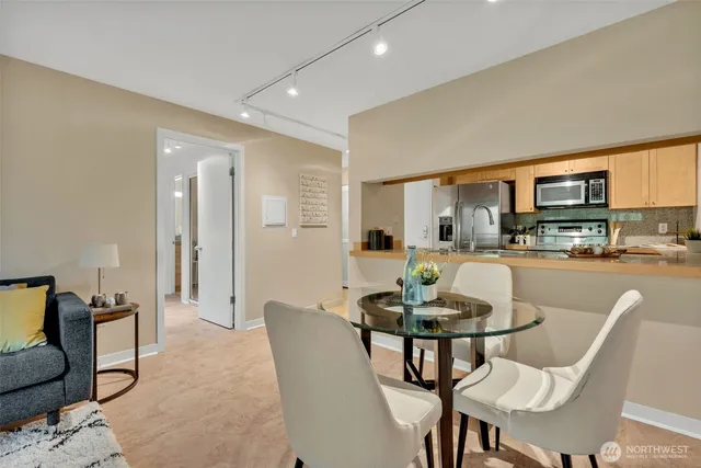 a living room with furniture and a dining table