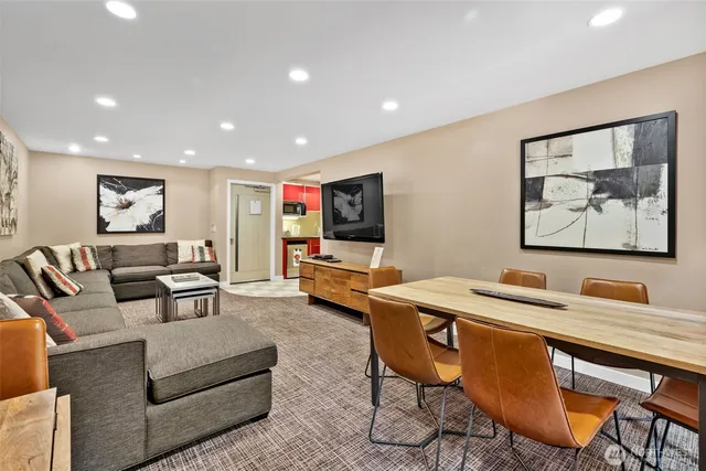 a living room with furniture a couch and large window