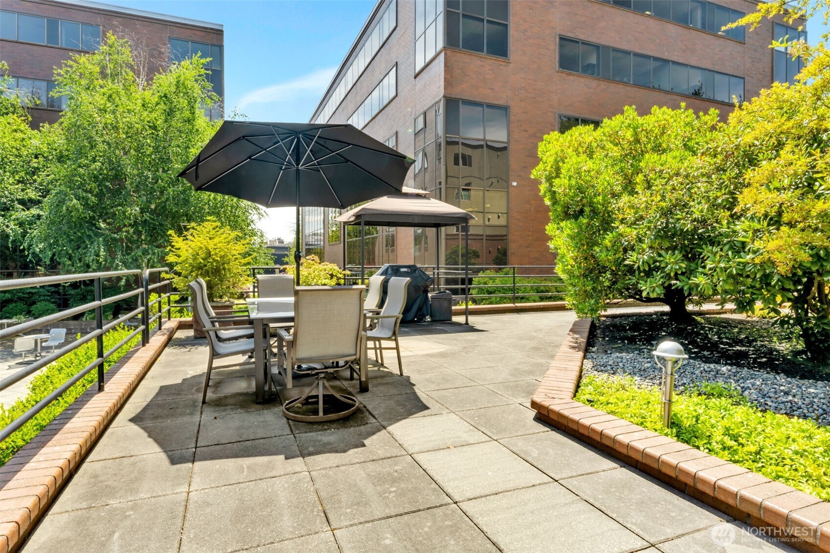 275 West Roy Street, Unit 319 Seattle, WA 98119 - Photo 28 of 30 a view of a patio with a table and chairs under an umbrella